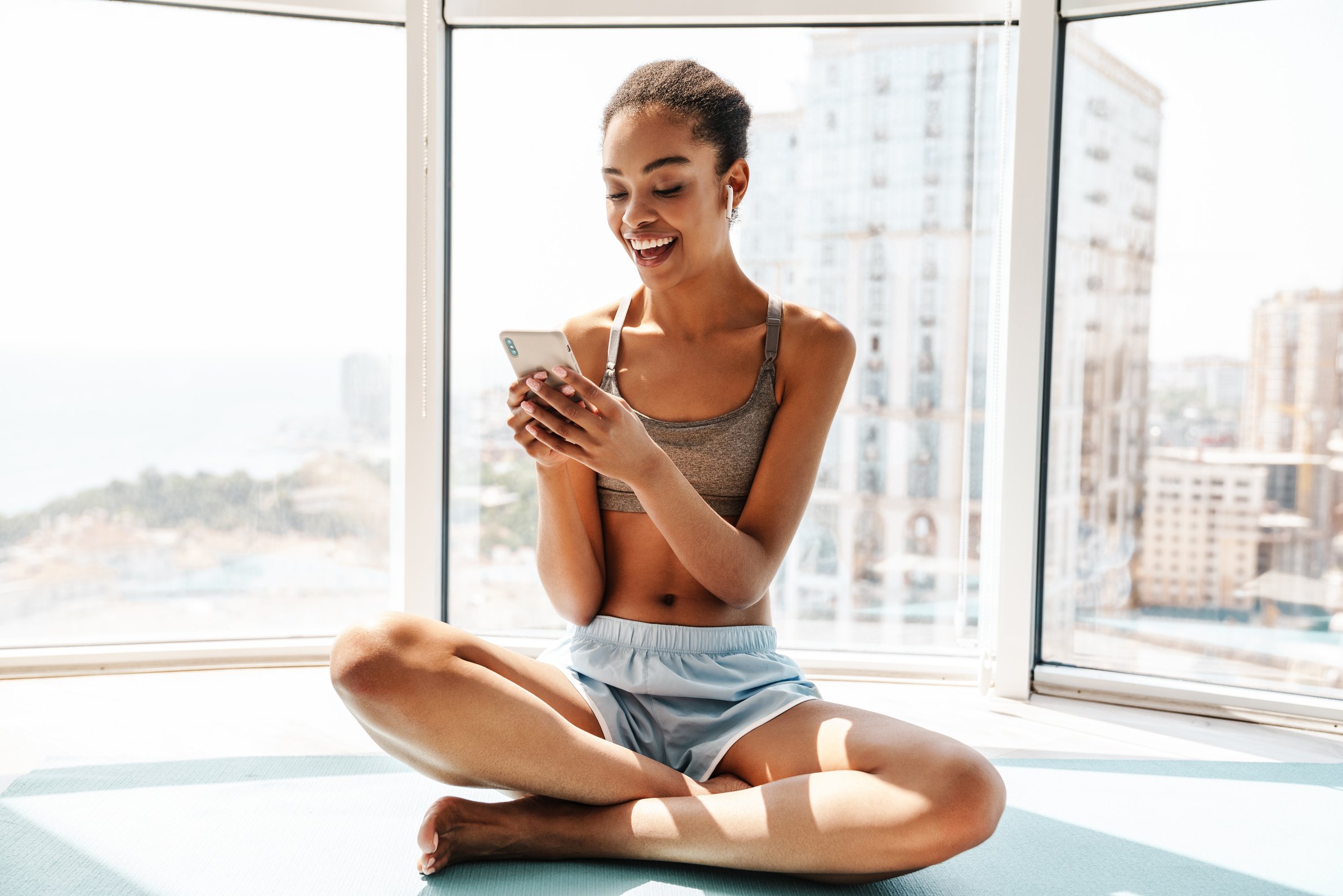 Happy Sports African Woman Using Mobile Phone